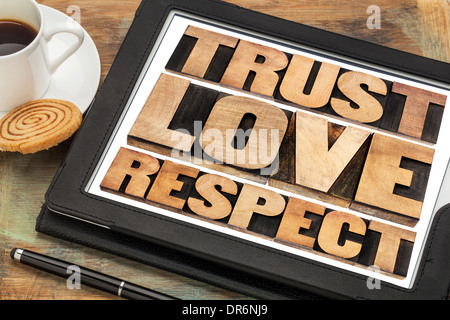 trust, love and respect word abstract in vintage letterpress wood type on a digital tablet Stock Photo
