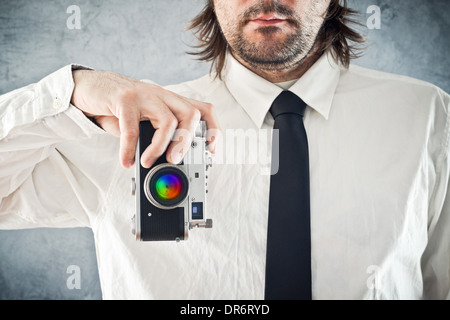 Businessman taking picture with retro style photo camera Stock Photo