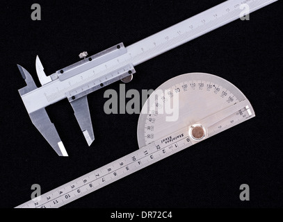 Vernier calipers and protractor isolated on black Stock Photo
