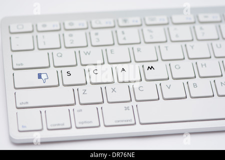 Computer Keyboard With Letters Spelling Out The Work Scam And Dislike Button Isolated On A White Studio Background Stock Photo