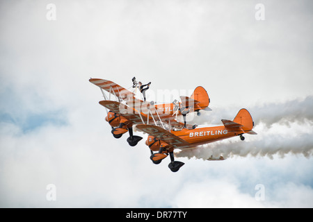 Two Boeing Stearman Biplanes from the AeroSuperBatics Breitling Wingwalking Team make a pass at RAF Fairford Stock Photo