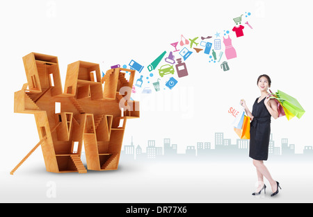 a woman with shopping bags next to a big sign of Korean currency Stock Photo