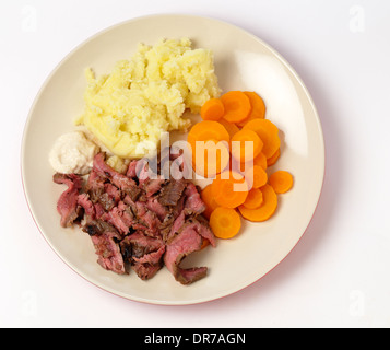'London broil' marinaded flank of beef steak grilled and sliced thinly, then served with  potato,  carrots and horseradish sauce Stock Photo