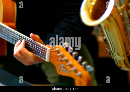 musicians playing saxophone and guitar Stock Photo