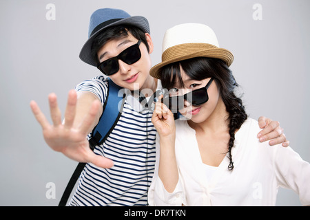 a couple with sunglasses posing together Stock Photo