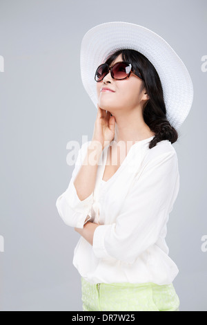 close up shot of a woman in white hat and sunglasses Stock Photo