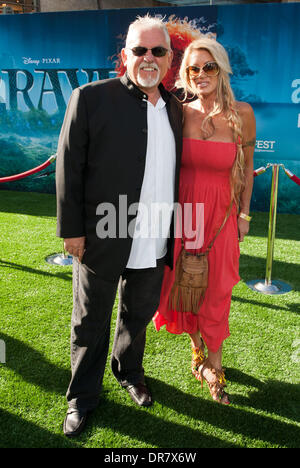 John Ratzenberger and Guest 2012 Los Angeles Film Festival premiere of Disney Pixar's 'Brave' at the Dolby Theatre  Hollywood, California - 18.06.12 Stock Photo