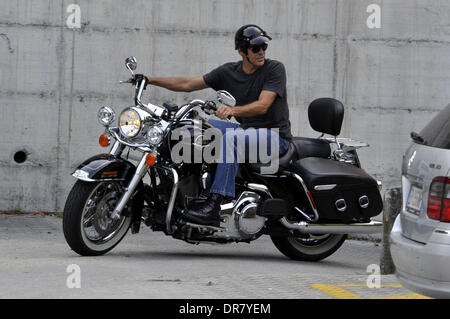 George Clooney riding a Harley Davidson motorcycle in Milan Milan