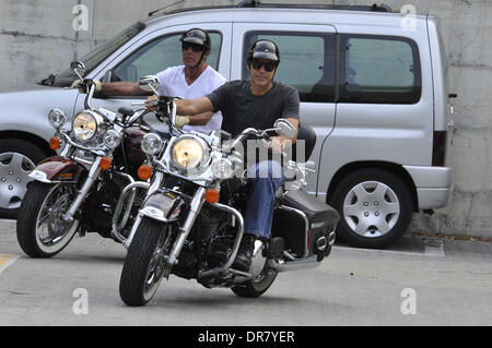 George Clooney riding a Harley Davidson motorcycle in Milan Milan