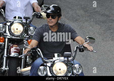 George Clooney riding a Harley Davidson motorcycle in Milan Milan