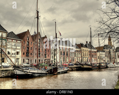 Sailing ships in winter in the Canal at Hoge der A in Groningen, The Netherlands with Der Aa-Kerk in the background Stock Photo