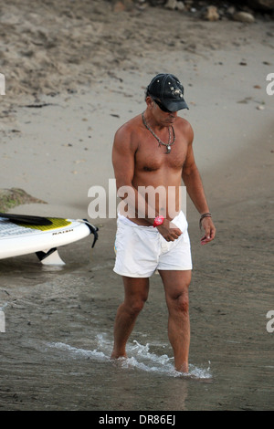 The singer Bruce Springsteen doing paddlesurf on a beach on holiday in Mallorca in 2013. Stock Photo