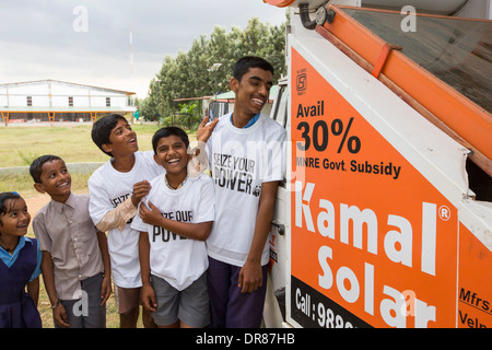 The Kamal factory in Bangalore, Karnataka, India that manufactures solar thermal panels for heating water, with children wearing WWF Seize your Power T shirts, a campaign to promote renewable energy. Stock Photo