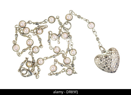 A heart shaped locket on a silver chain with imitation pearls on a white background. Stock Photo