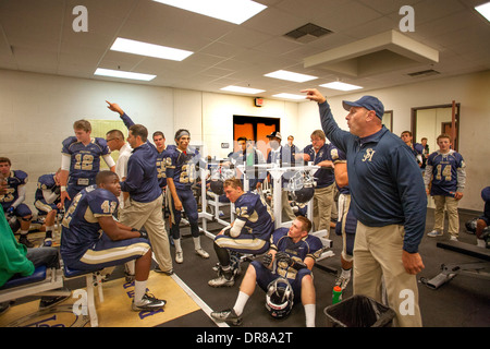 A high school football coach inspires his players during half time at a game in San Juan Capistrano, CA. Stock Photo