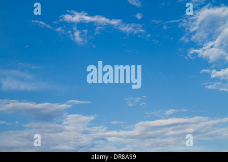 Puffy white clouds set against a perfect blue sky. Stock Photo