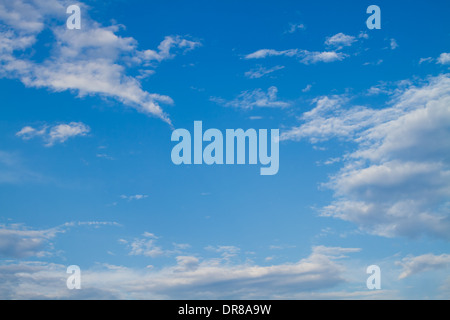 Puffy white clouds set against a perfect blue sky. Stock Photo