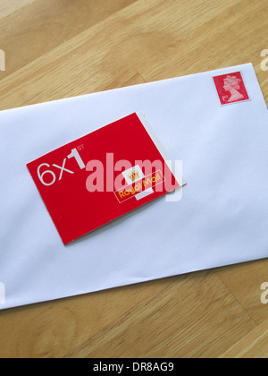 Book of First Class Royal Mail Stamps and Envelope, UK Stock Photo