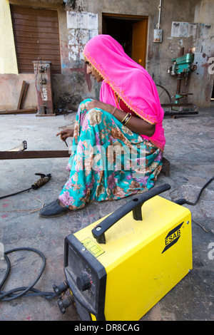 Women testing the welding joints during the construction of solar cookers at the Barefoot College in Tilonia, Rajasthan, India. Stock Photo