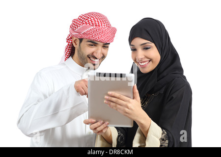 Arab saudi happy couple browsing a tablet reader isolated on a white background Stock Photo