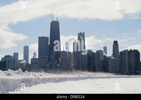 Chicago, USA. 21st January 2014.  Icicles formed by waves from the latest lake effect storm drape the seawall at North Avenue Beach as snow blows in front of the city's downtown skyline. The polar vortex has returned bringing frigid temperatures. Credit:  Todd Bannor/Alamy Live News Stock Photo