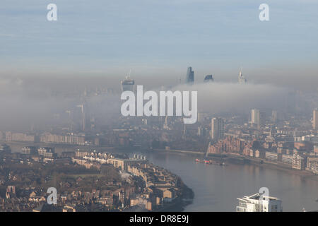 London UK, 21st Jan 2014. A bank of low fog shrouds the City of London and surrounding areas. The tops of some of London's tallest buildings are visible above the fog. This shot was taken from Canary Wharf. © Steve Bright/Alamy Live News Credit:  Steve Bright/Alamy Live News Stock Photo