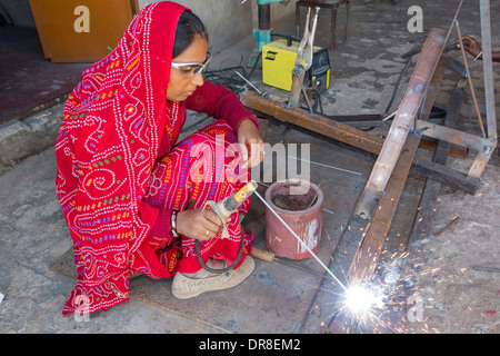 Women welding joints during the construction of solar cookers at the Barefoot College in Tilonia, Rajasthan, India. Stock Photo