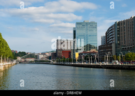 A view of Santiago Calatrava-designed Zubizuri footbridge, the Nervion River, and new skyscrapers in Bilbao, Spain. Stock Photo