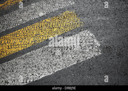 Pedestrian crossing road marking on dirty asphalt pavement Stock Photo