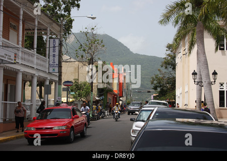 Small urban road in the city of Puerto Plata, Dominican Republic with the mountains in the background Stock Photo