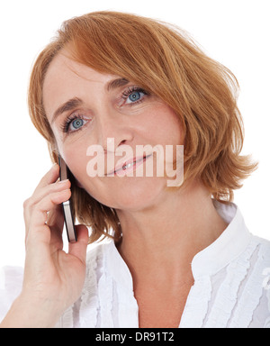 Middle aged woman using smart phone. All on white background. Stock Photo