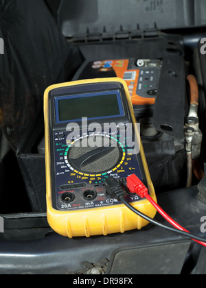 Multimeter set up and ready for taking car battery voltage measurement Stock Photo