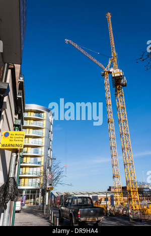 Cranes working on a construction site building new homes in central Reading, Berkshire, England, GB, UK. Stock Photo