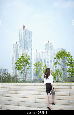 a business woman walking up stairs Stock Photo