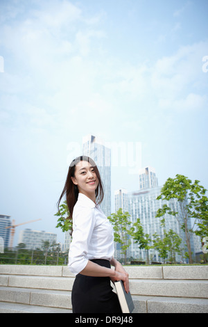 a business woman walking up stairs Stock Photo