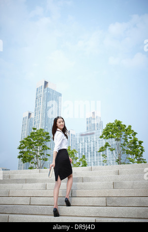 a business woman walking up stairs Stock Photo