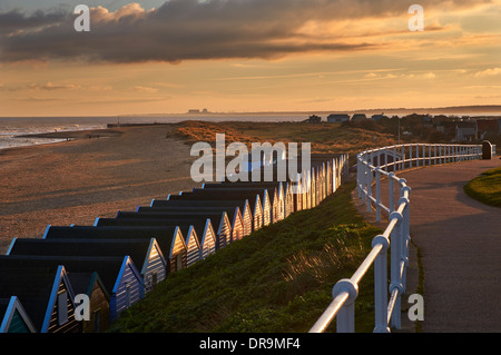 Beach huts at Southwold with Sizewell Nuclear Power Stations in distance. Suffolk, England. Stock Photo
