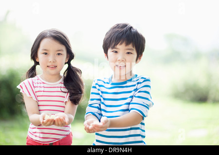 kids holding a couple of flowers Stock Photo