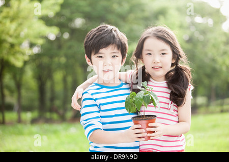 kids holding a plant Stock Photo