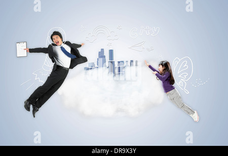 businessman and kid jumping in the air Stock Photo