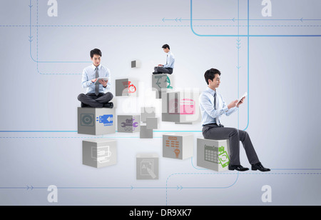 businessmen sitting on icon cubes Stock Photo