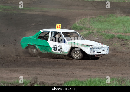 Race for survival. Green white car on the track Stock Photo