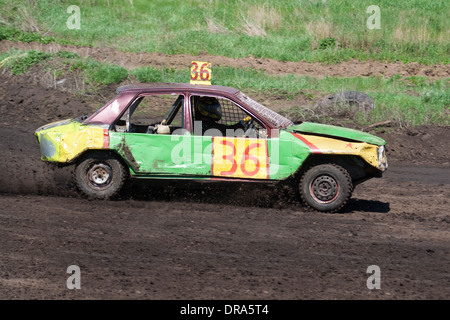 Race for survival. Green yellow car on the track Stock Photo