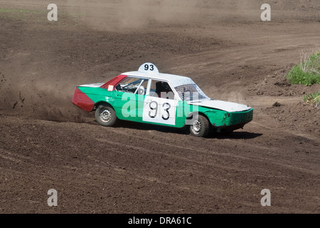 Race for survival. White green car on the track Stock Photo