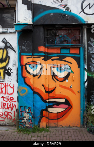 Graffiti on a building door and wall in Amsterdam, Holland, the Netherlands. Stock Photo