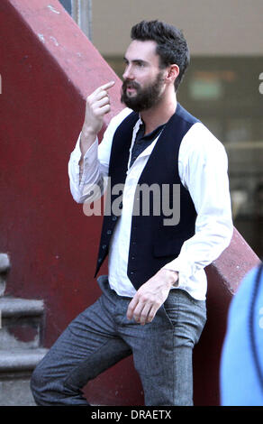 Adam Levine filming on the set of his new movie 'Can A Song Save Your Life?' in Manhattan. The new John Carney movie centers around a dejected music business executive who ends up forming a friendship with a young singer-songwriter who is new to Manhattan. New York City, USA - 03.07.12 Stock Photo