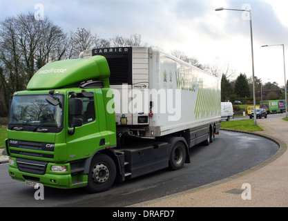 An articulated Waitrose truck traveling around a roundabout in Coulsdon, Surrey, England Stock Photo