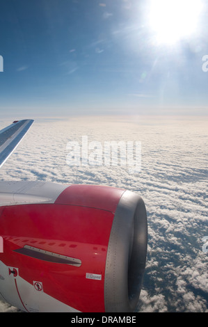 View of clouds and aircraft wing through window of Air Philippines ...