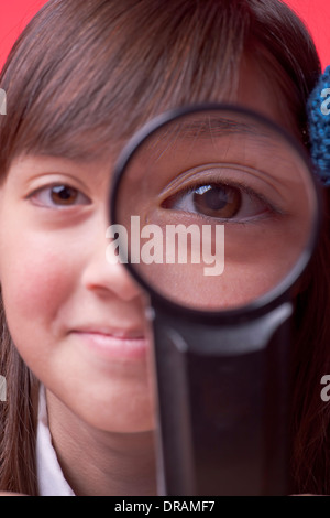 Girl looks through lens. Stock Photo