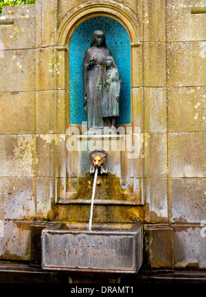 Spring water flowing out of St Ann's Well in the spa town of Buxton in the High Peak Derbyshire England famous for its waters Stock Photo